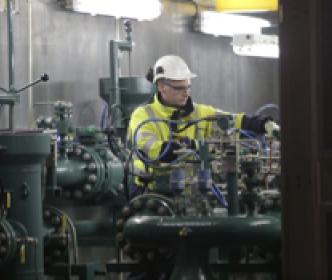 An Uisce Éireann worker working machinery at a water treatment plant