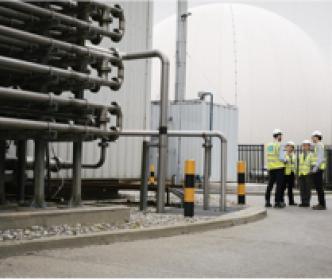 A group of Uisce Éireann workers talking at a water treatment plant