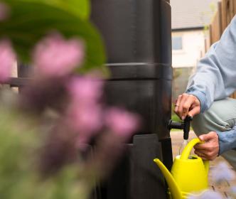 A woman filling a watering can