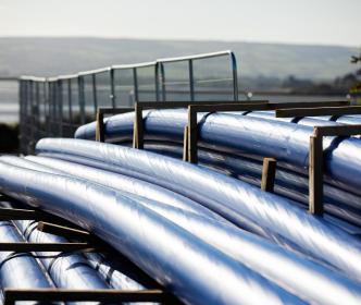 A pile of blue pipes in the countryside