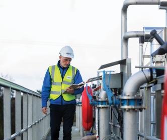 An Uisce Éireann worker drilling the ground