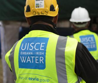 Uisce Éireann worker examining something on site 