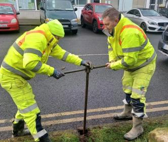 Uisce Éireann workers fixing issues with the water supply on a street