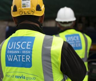 uisce eireann workers examining something on a site 